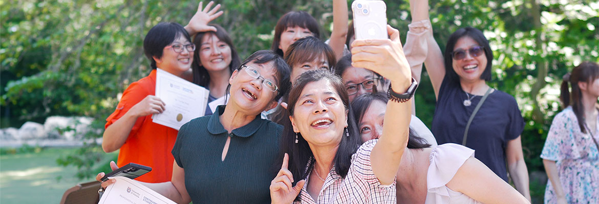 students celebrating and taking a selfie