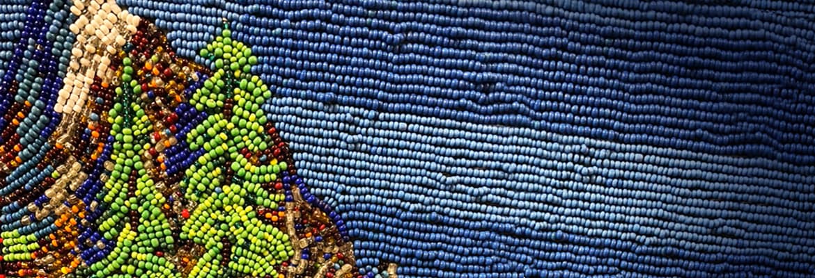 Beaded work depicting forest and ocean.