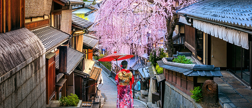 Woman wearing japanese traditional kimono walking at Historic Higashiyama district in spring, Kyoto in Japan.