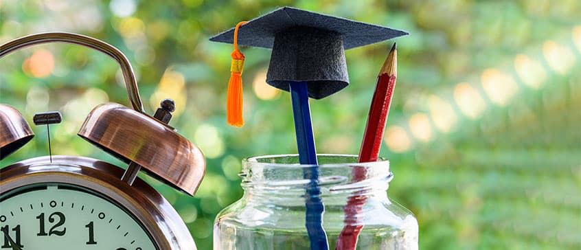 Photo of mini graduation cap on pencil. 