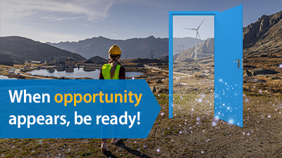 A door opening to a woman with hard hat in field with a windmill