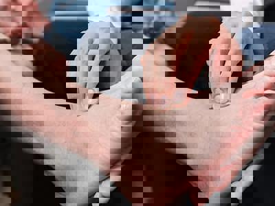 A healthcare practitioner examining a foot.