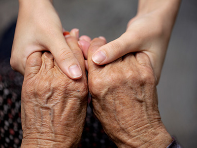 Closeup of young hands holding old hands