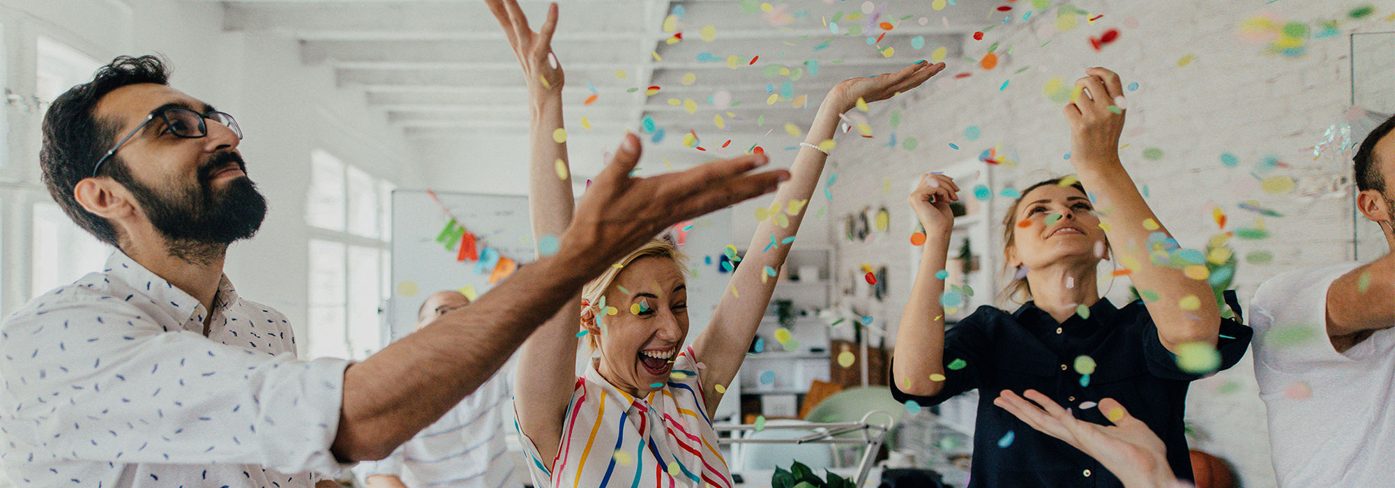 People throwing confetti in the air.