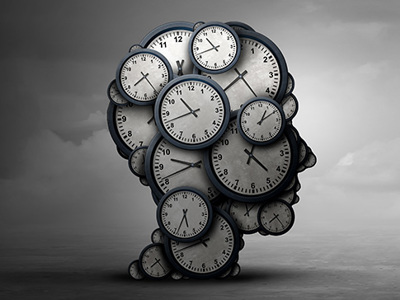 A silhouette of a head made of clocks with varying times is set against a gradient gray sky. Darker on the left, lighter on the right, it visually represents time's passage and shifting emotional states, relevant to the concept of grief.