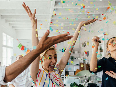 Coworkers throwing confetti in the air