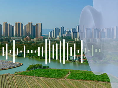 Panoramic view of a modern city skyline with high-rise residential buildings in the background, overlooking agricultural fields and farmland in the foreground, with a translucent overlay of white data visualization bars resembling an audio waveform or statistical chart, and a subtle ghosted profile of a human head on the right side, symbolizing the intersection of urban development, environmental factors, and human health analysis.