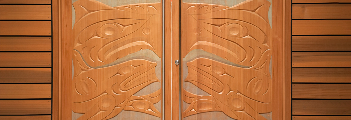 Xwa Lack Tun’s (Rick Harry) carved doors to the Ceremonial Hall in the First Peoples House at the University of Victoria.