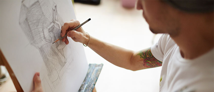 Photo of a man drawing. 