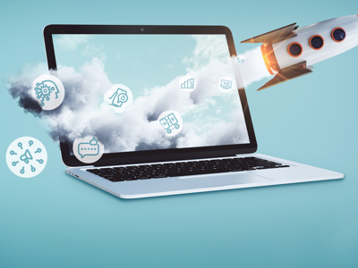 
A white laptop computer is open and facing left on a light blue background. A stream of white clouds billows out from the laptop screen, moving towards the right. Embedded within the clouds are several white line-art icons related to digital marketing. A rocket with an orange nose cone and fins is launching upwards from the right side of the laptop, leaving a trail of smoke and fire. Additionally, two other icons, a megaphone and a speech bubble, are positioned to the lower left of the laptop, outside the cloud stream. This image symbolizes the rapid growth and diverse tools within digital marketing.