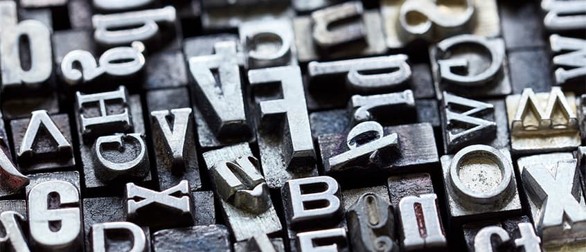 Closeup photo of vintage metal letterpress. 