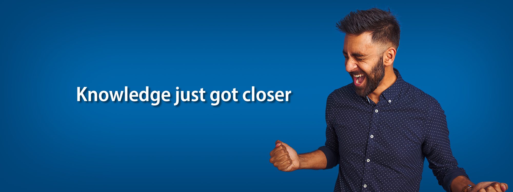 Man celebrating with clenched fist with text that reads, “Knowledge just got closer”