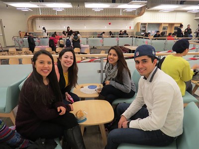 Four students talking in a student lounge