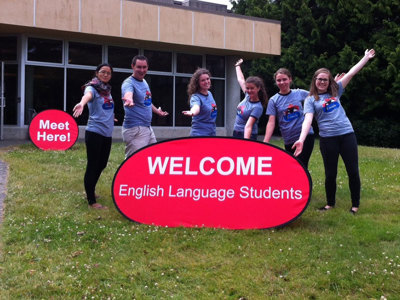Cultural Assistants with a welcome sign