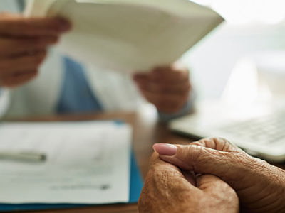 Close up of unrecognizable senior woman feeling worried during an appointment at doctor
