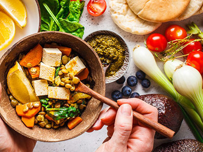 Photo of healthy power bowl with a background of various vegetables.