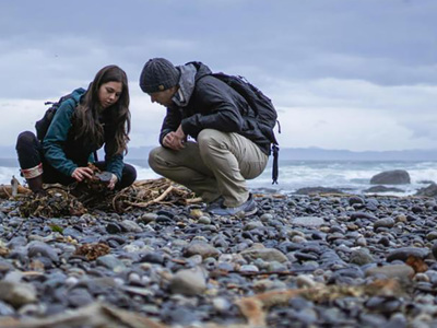 Two people monitoring the shoreline