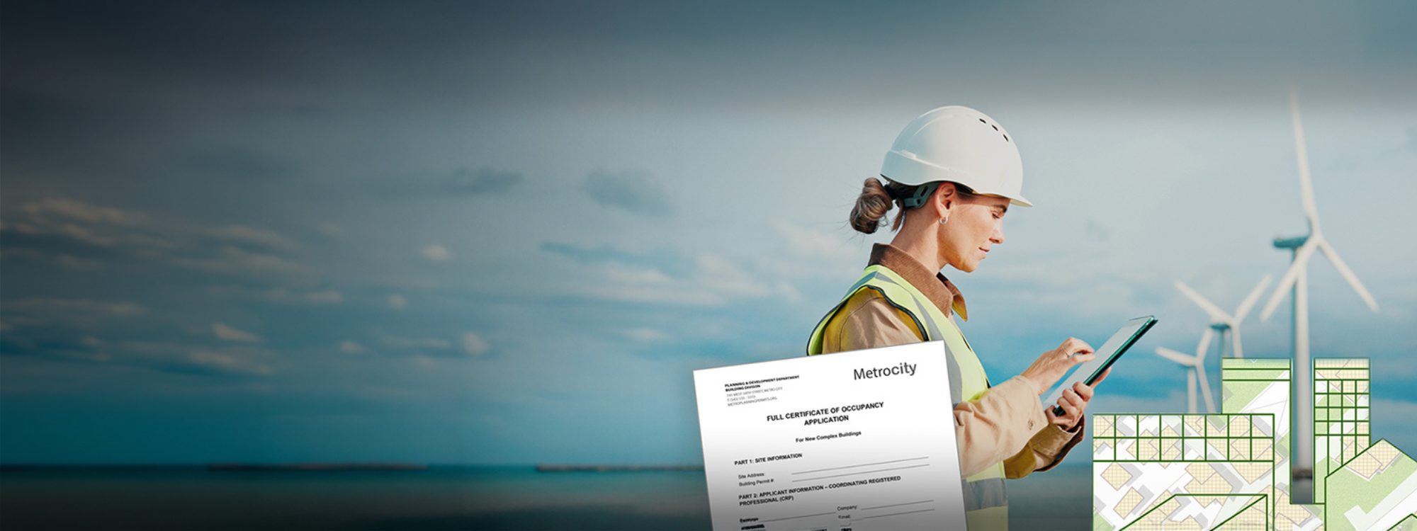 Woman in hard hat and safety vest using a tablet, with wind turbines and green buildings in the background.