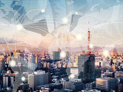 Image of a city skyline with a map of the world ontop.