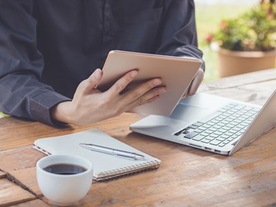 Photo of student working on an iPad in an office